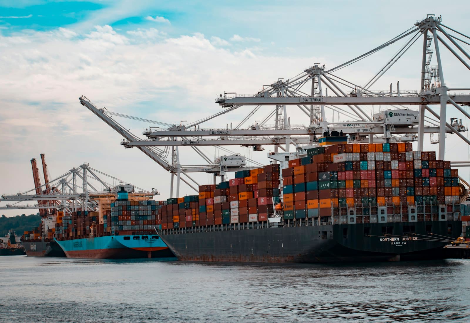 Container ship berthed at a port terminal with gantry cranes working
