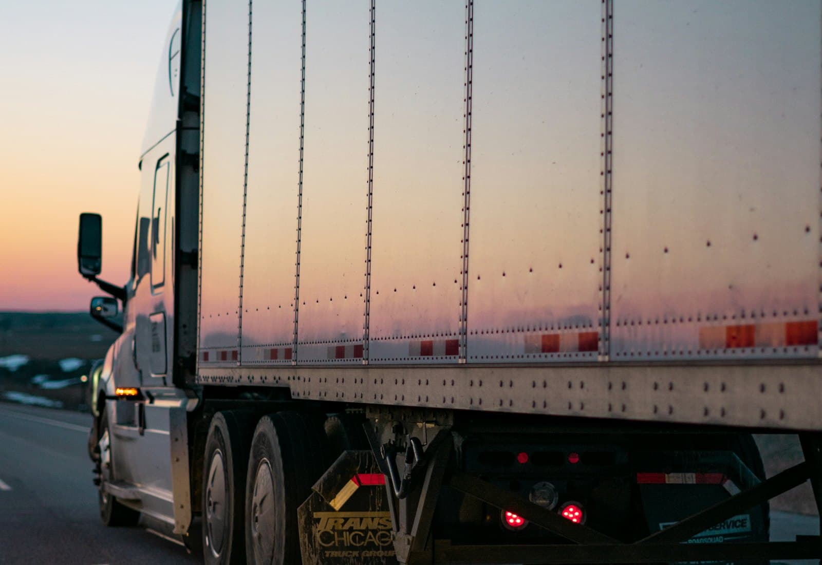 Dry van trailer running an interstate highway at dusk