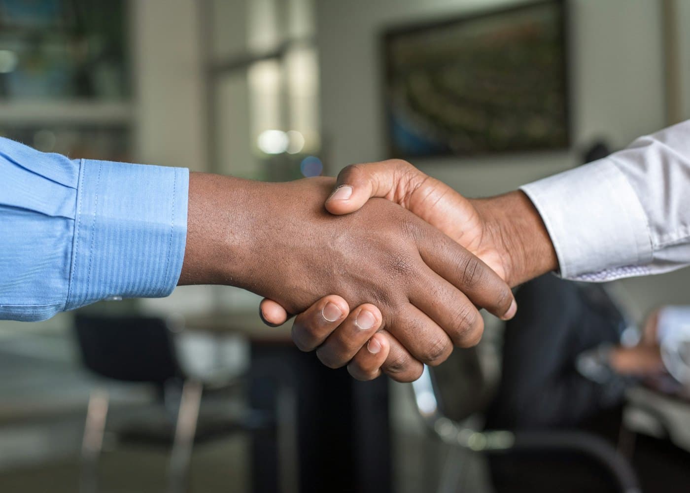 Two business partners shaking hands after agreeing terms