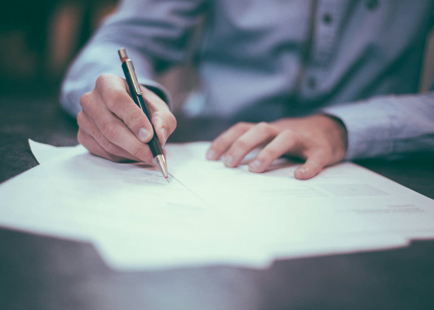 Carrier signing an operating agreement at a desk