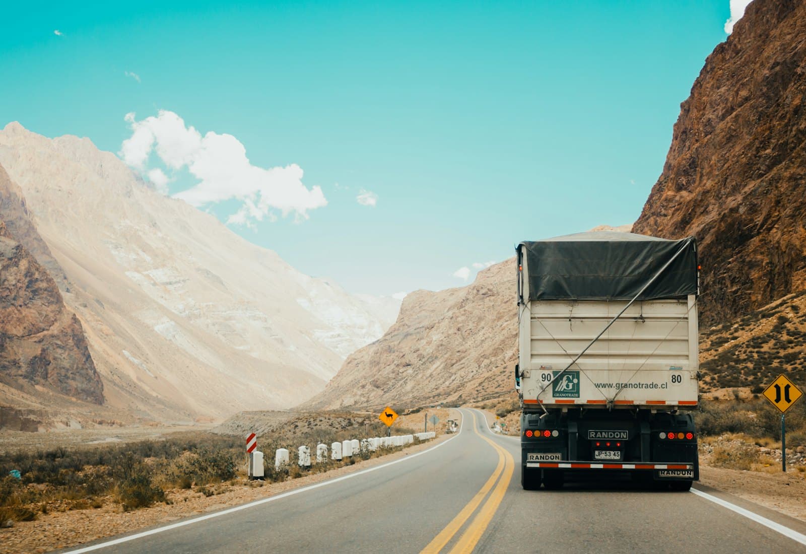 Semi-truck climbing a mountain highway at golden hour