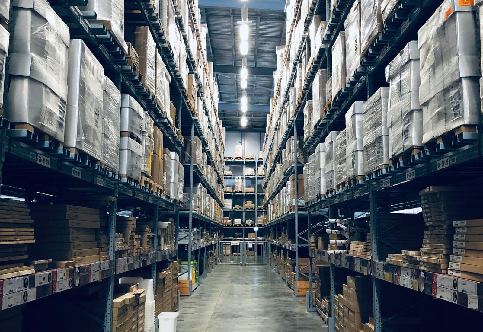 Long warehouse aisle lined with racked and palletized freight